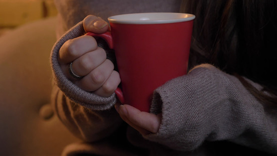 Hands holding a red cup
