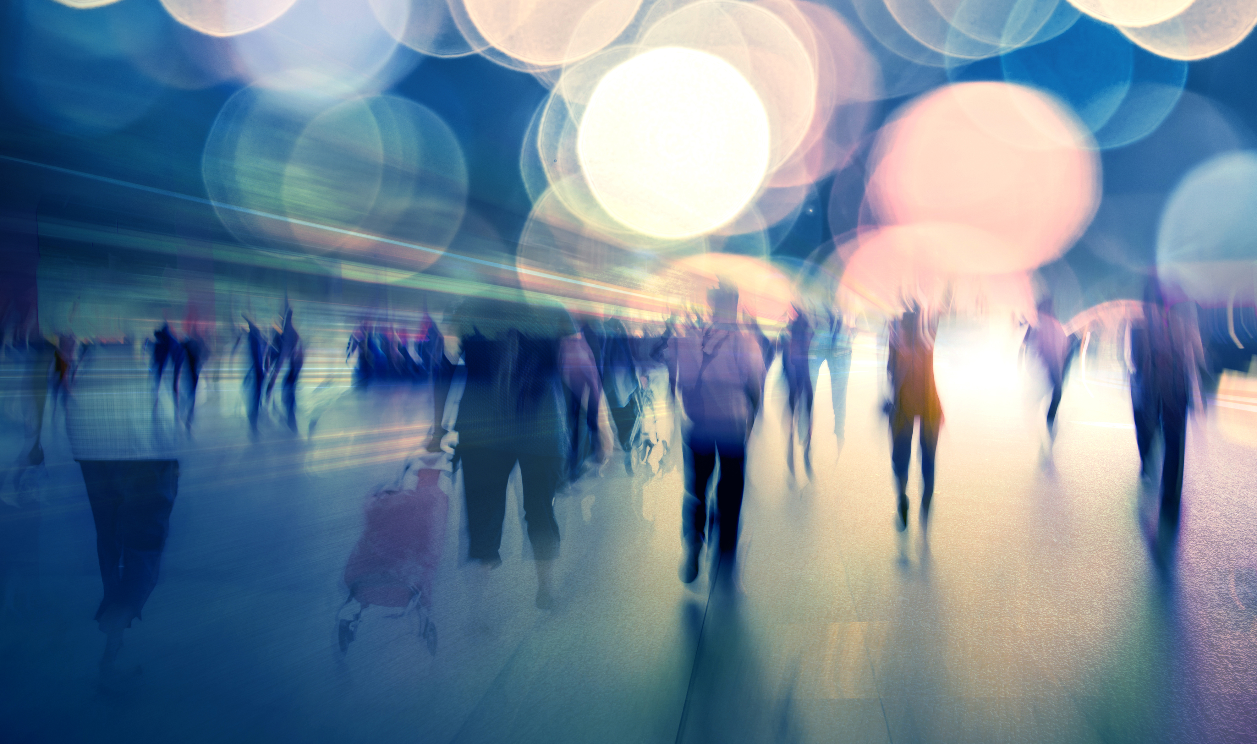 Fuzzy images of people walking in light