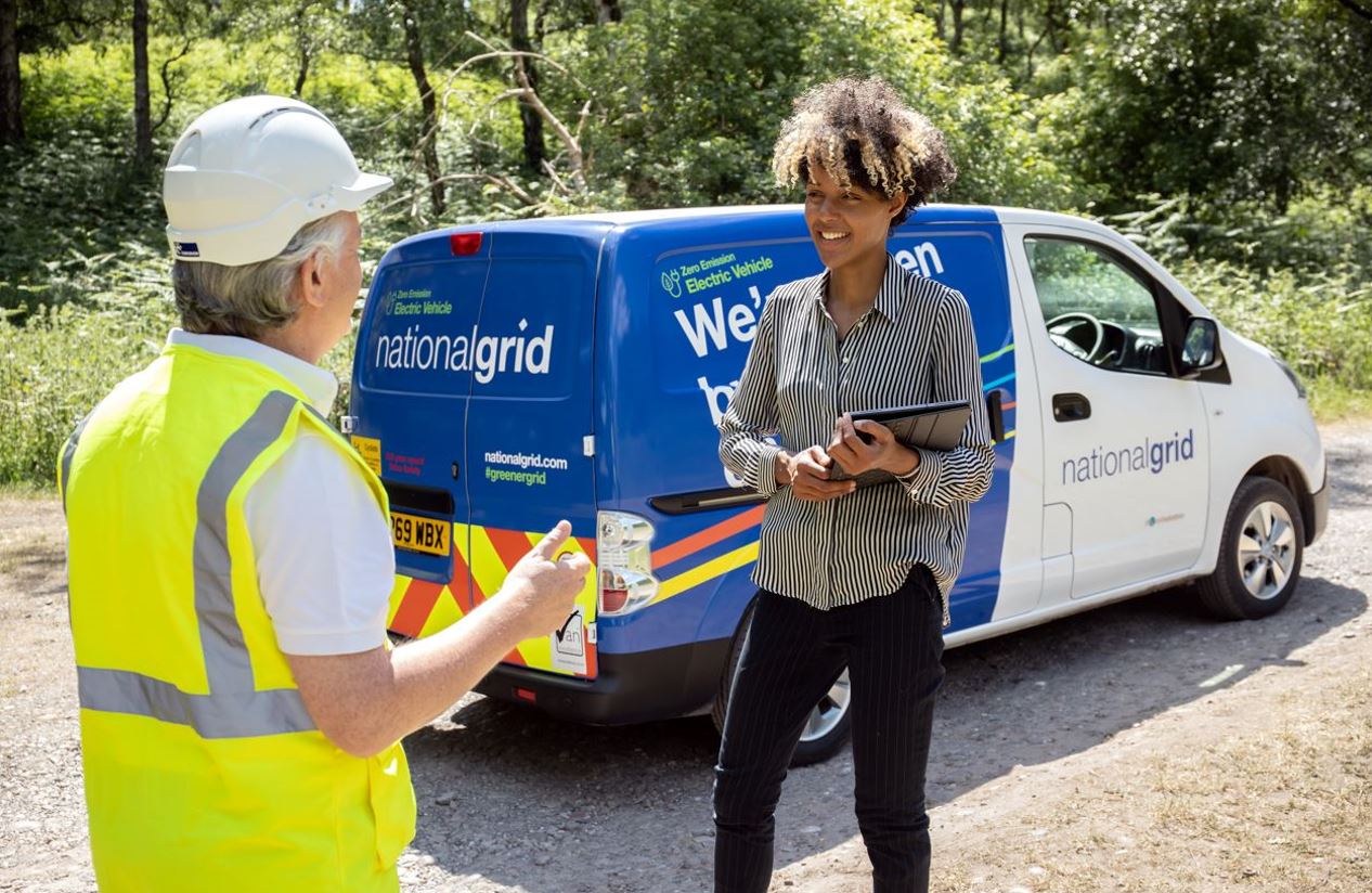 Man and lady standing near van