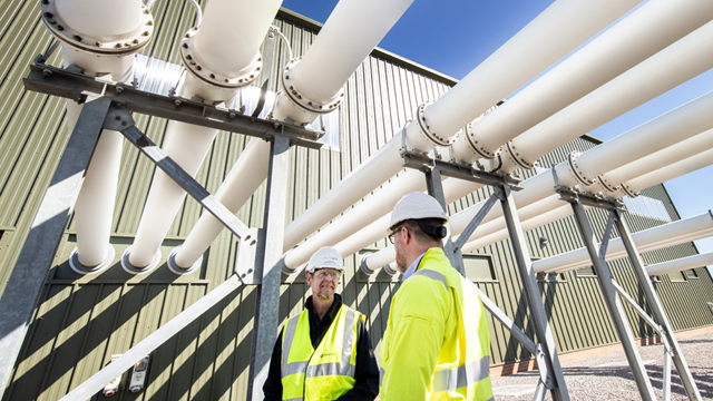 Two engineers wearing hard hats and high-vis vests at the Richborough Connection Project