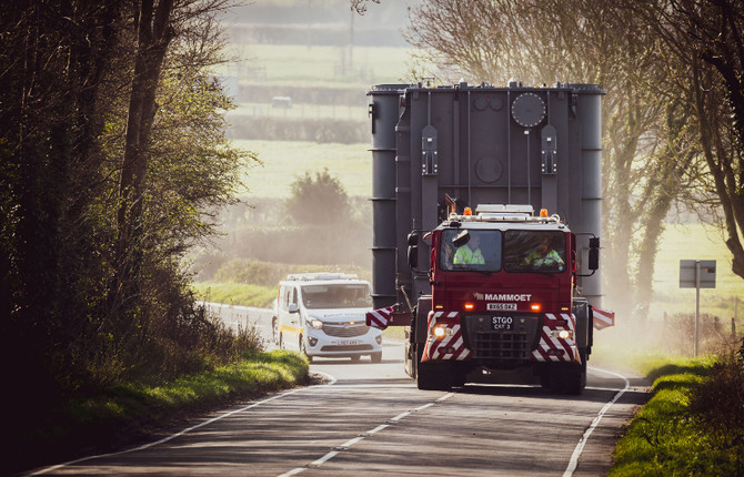 New series reactor on lorry on narrow road followed by escort vehicle