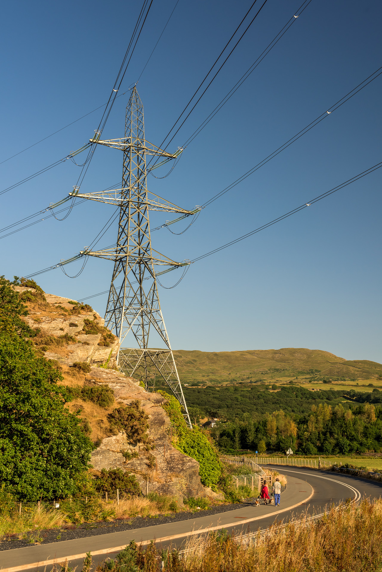 Close-up of electricity transmission tower in hilly landscape in Snowdonia, Wales