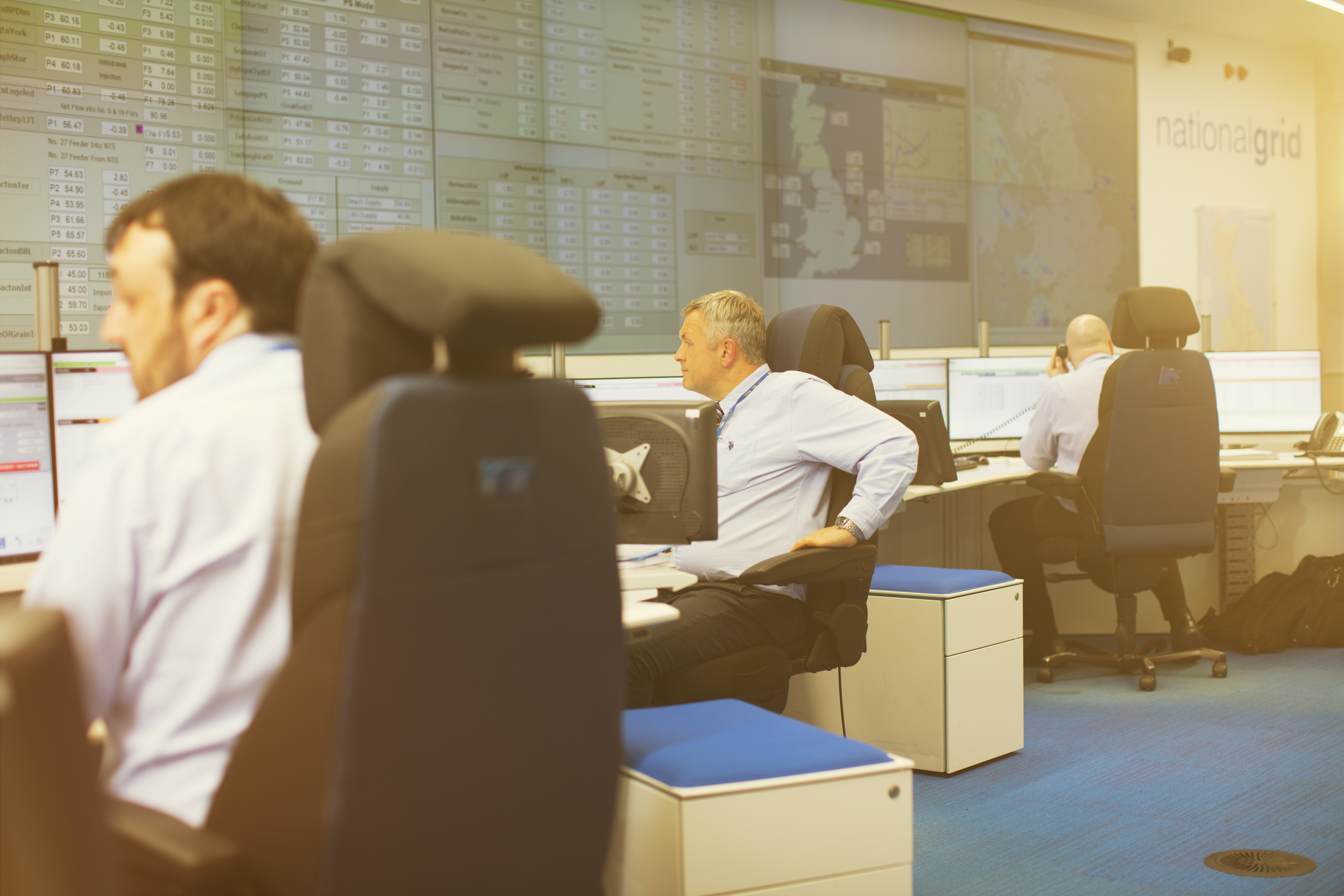 National Grid employees looking at data screens in a Gas National Control Centre office 