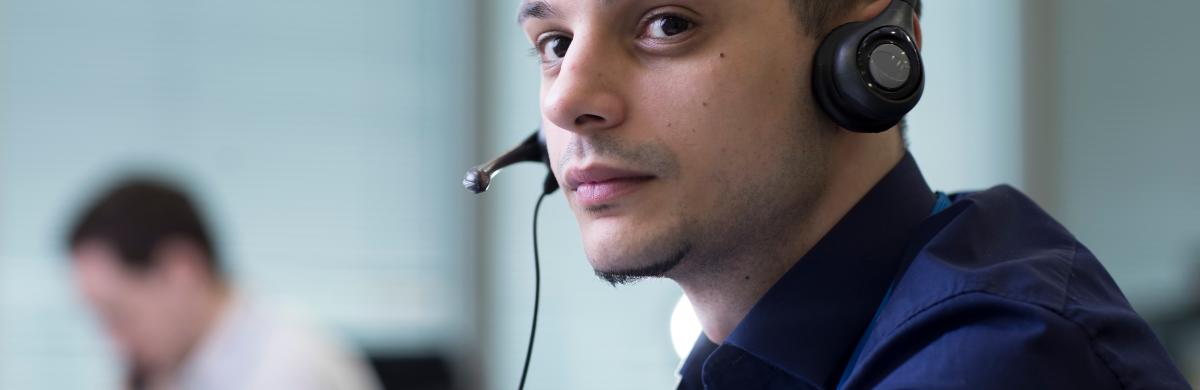 National Grid representative wearing a headset with an out of focus background 