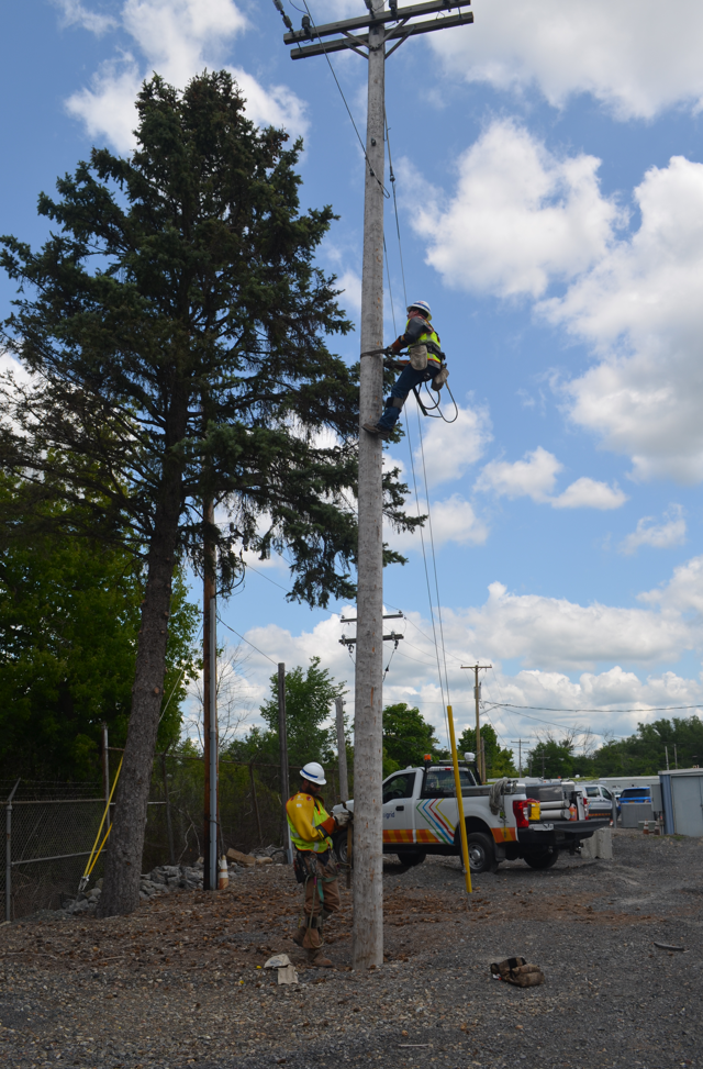 A man standing on a pole