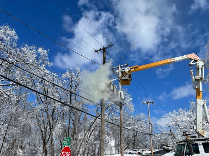 Storm response utility crew repairing power lines