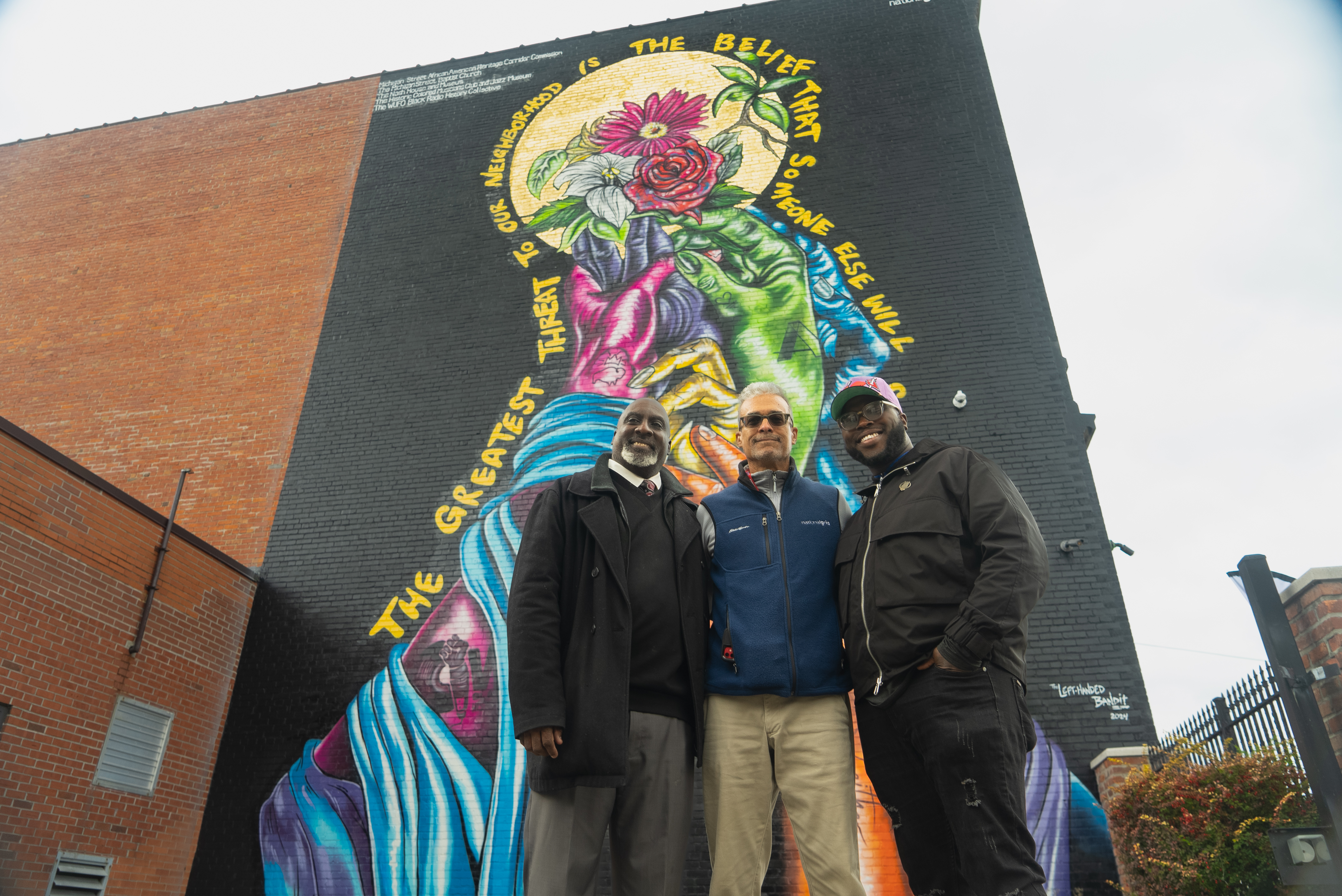 Group of people in front of wall art