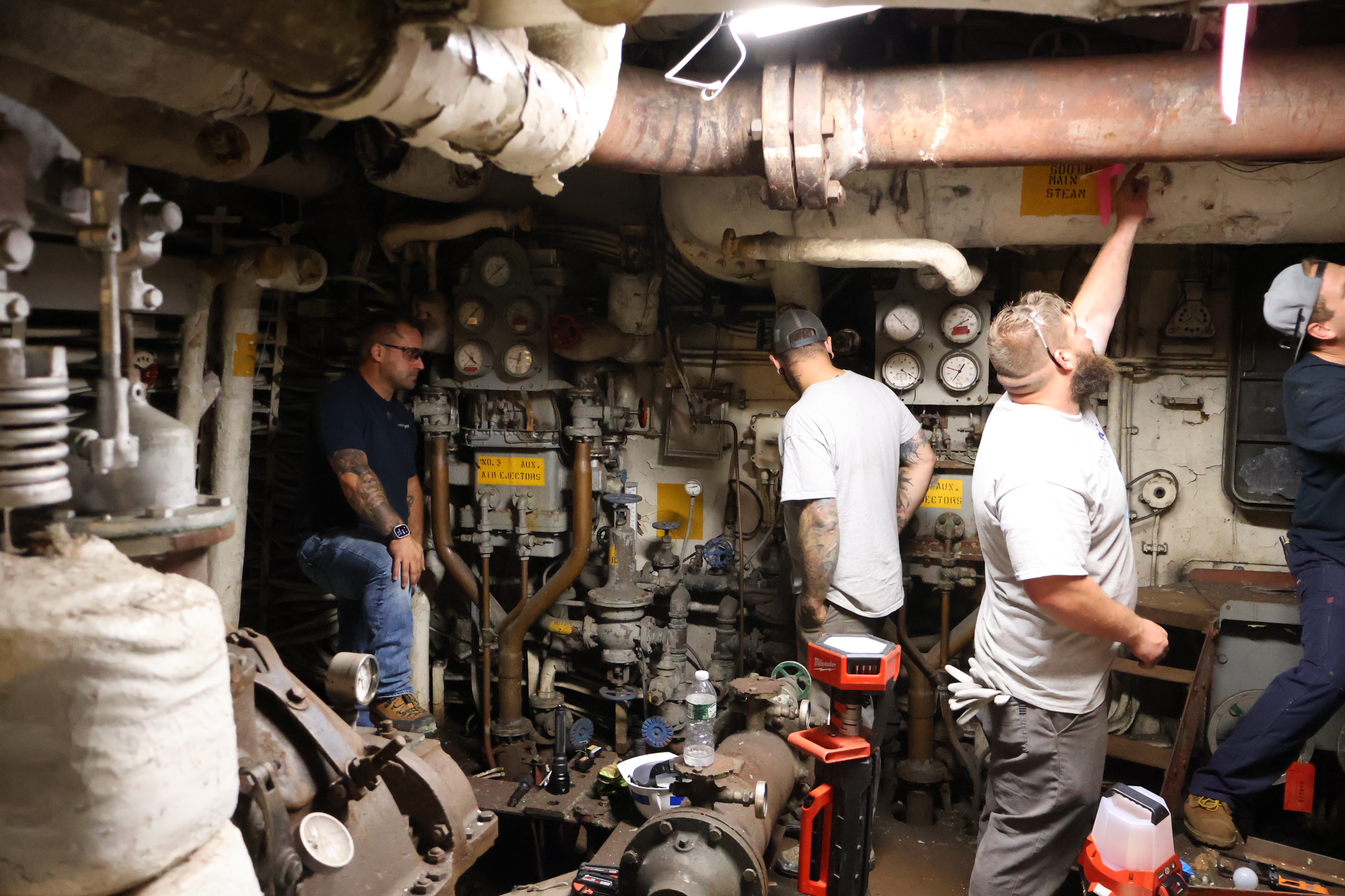 Employees working inside engine room