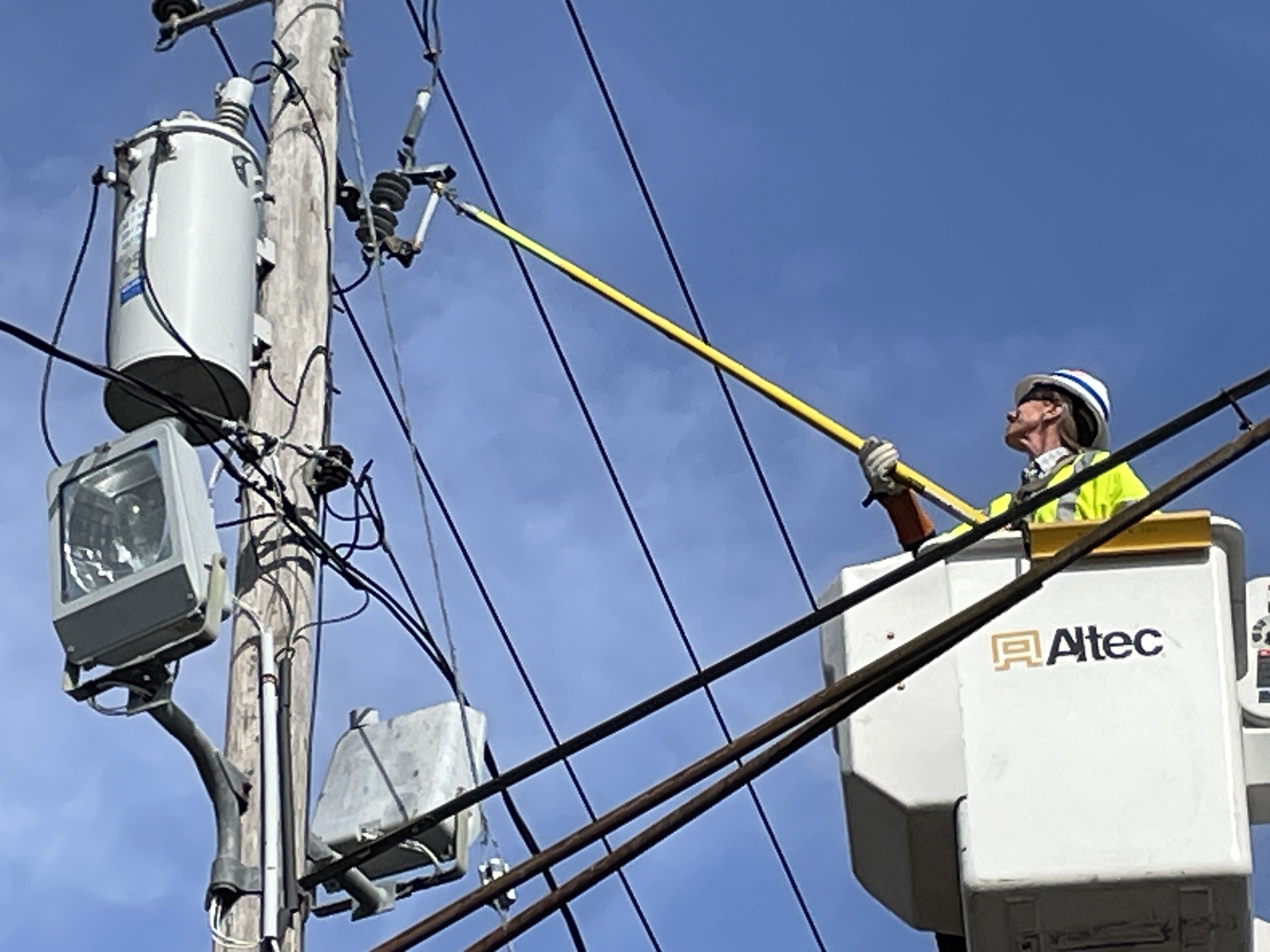 A Person repairing the Electric Pole
