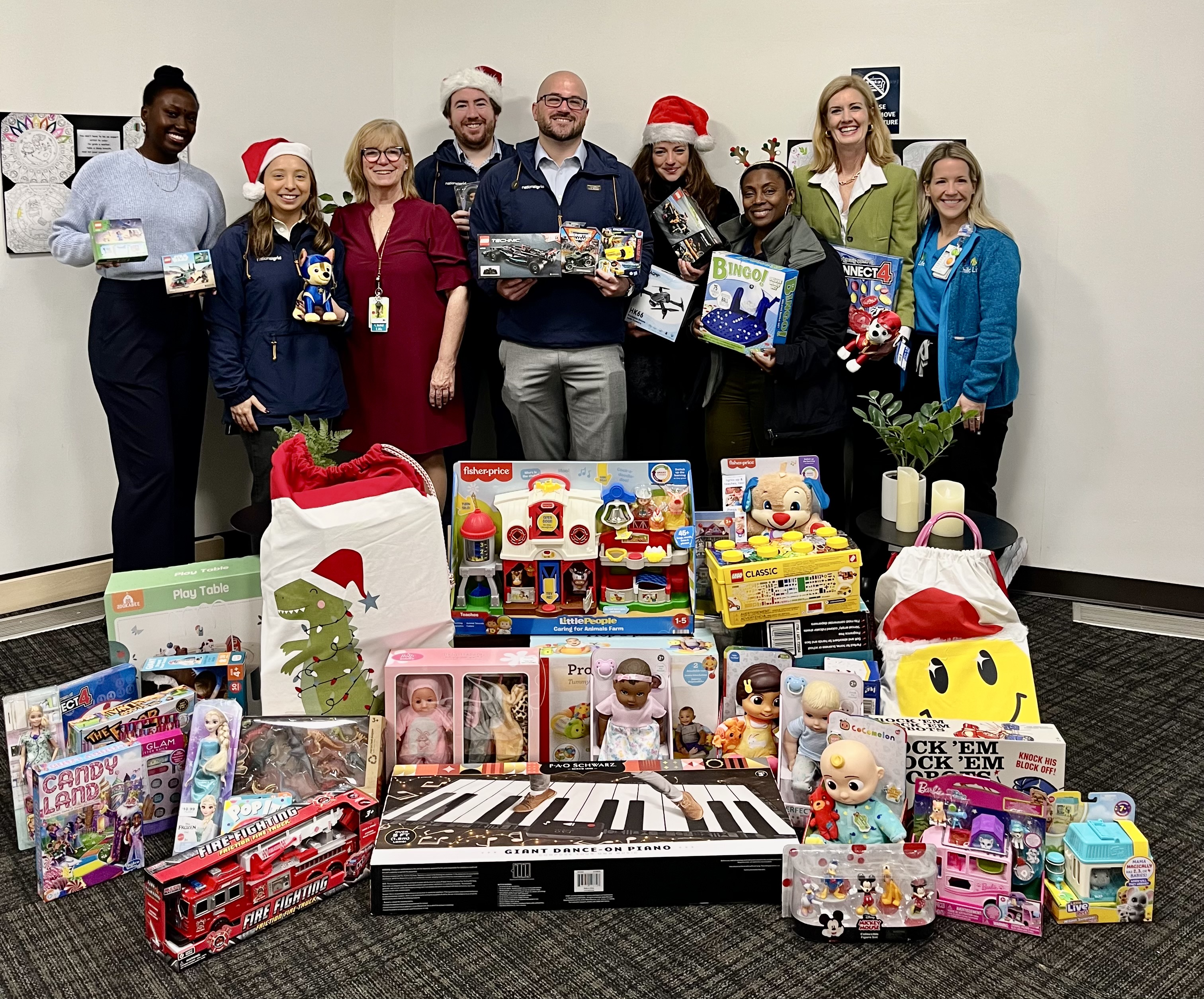 A Team of People Standing in front of Gifts