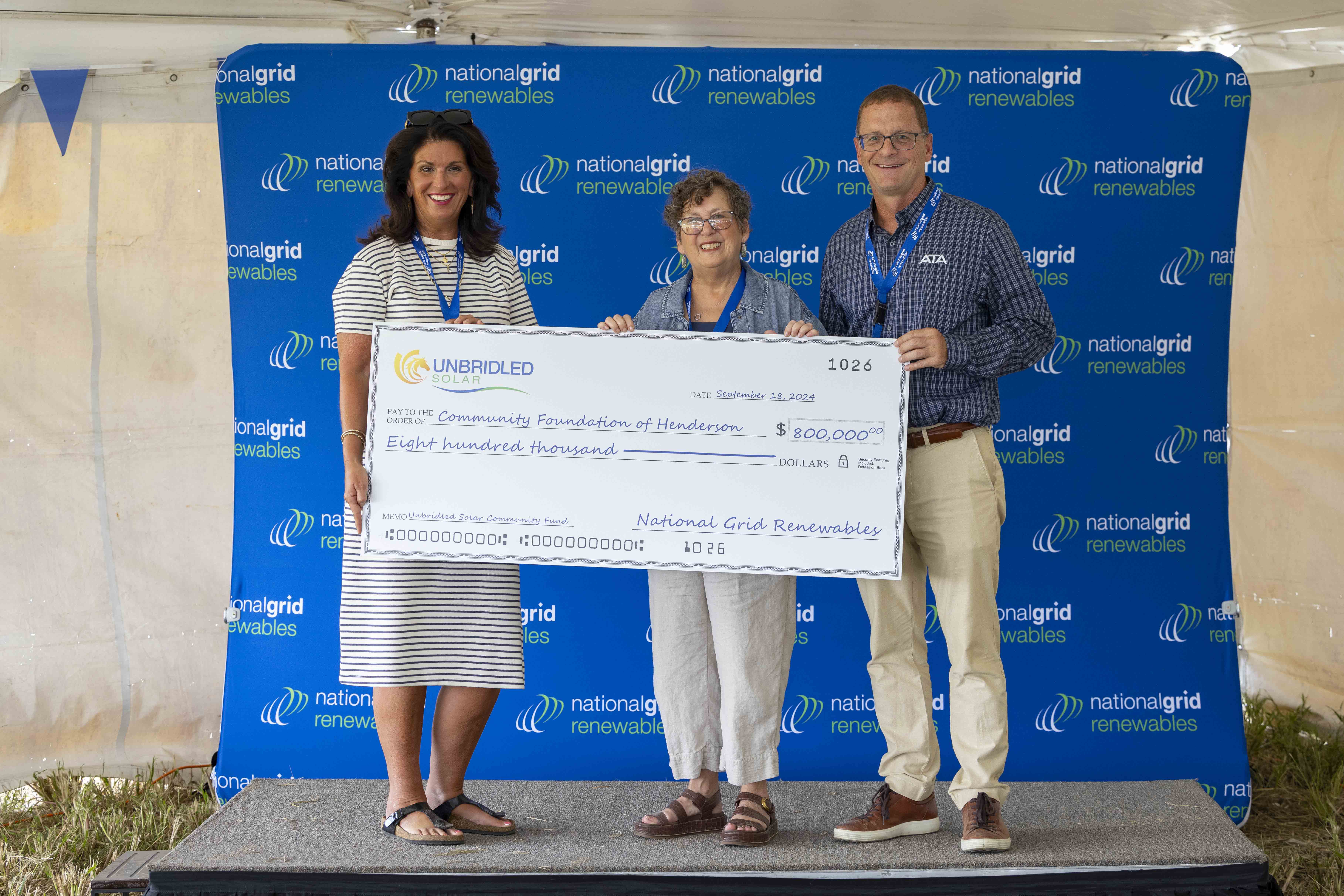 Team presenting donation check for solar project