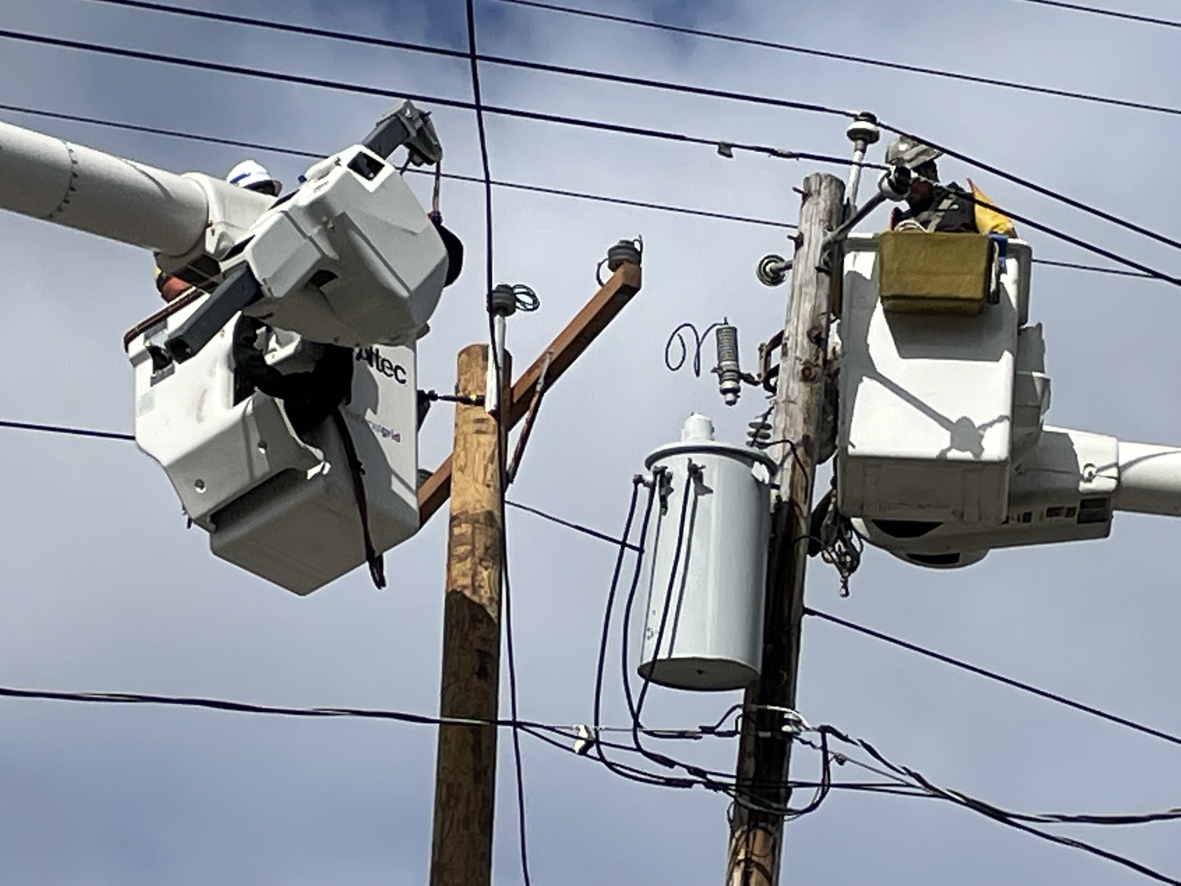 Crew members repairing power line