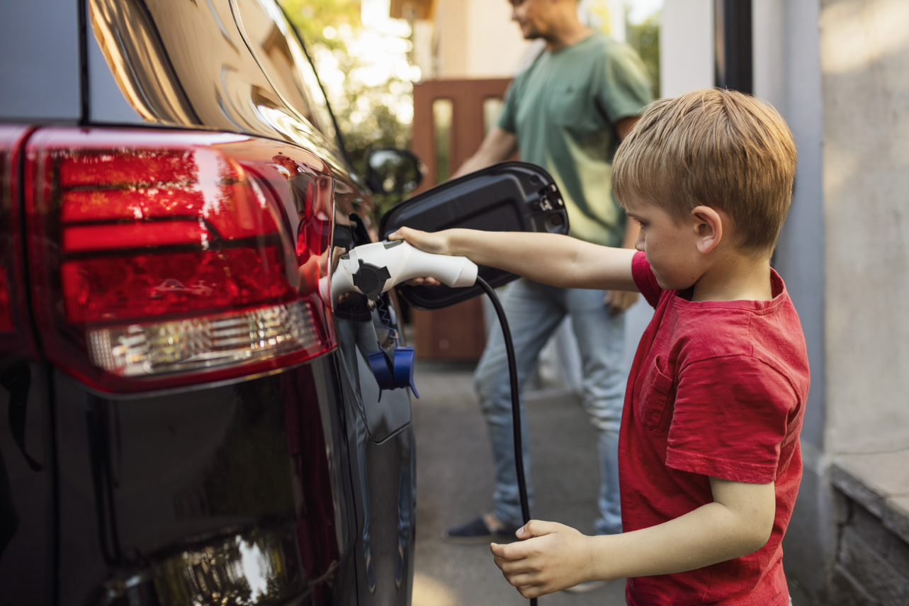 Child charging an electric car