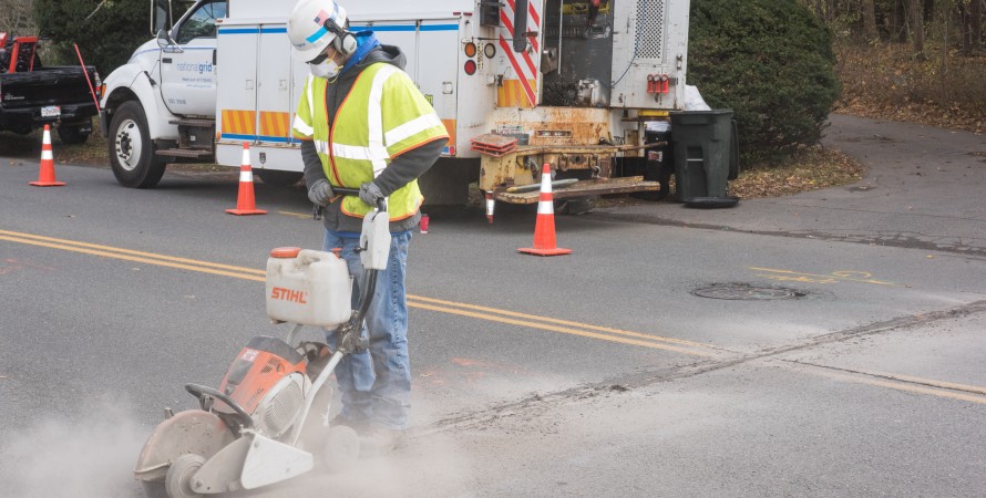 Crew members repairing road