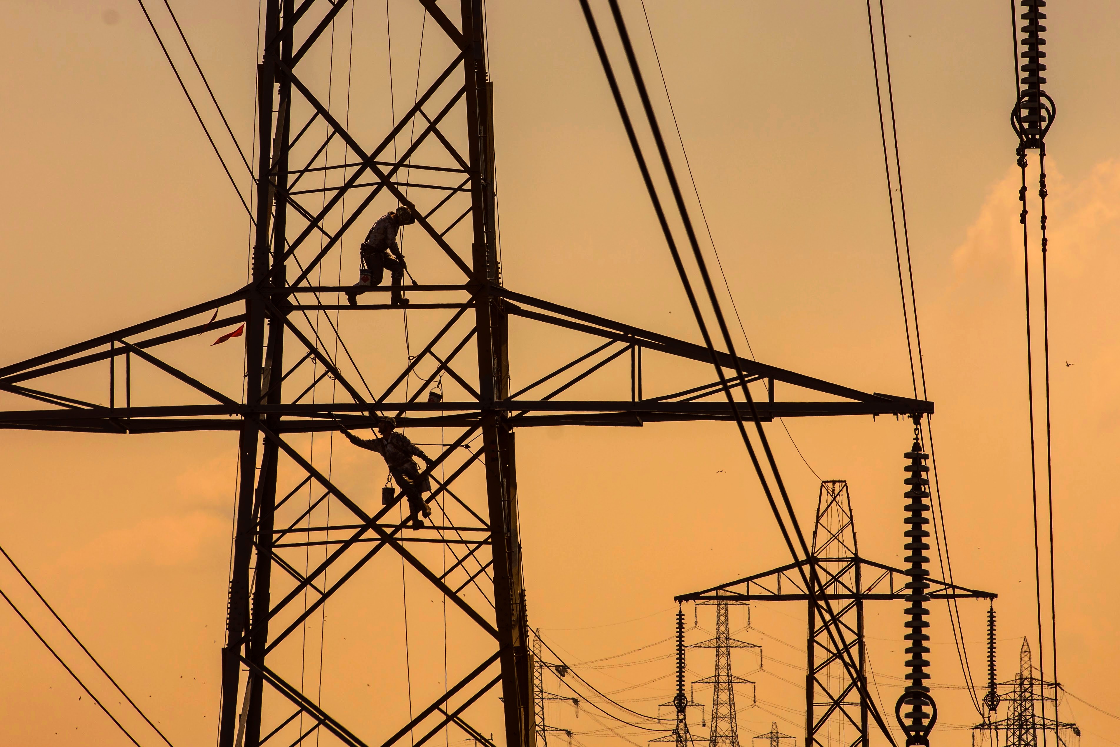 A pylon being refurbished at sunset