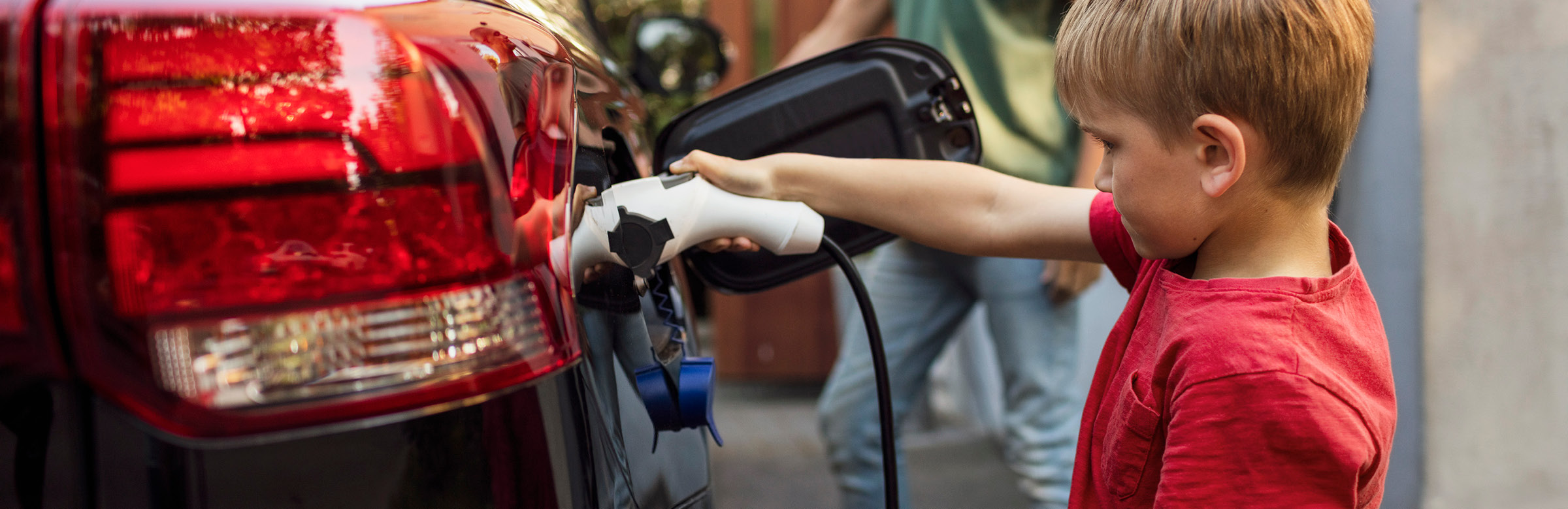 A child holding a fuel lead into a car - Our progress