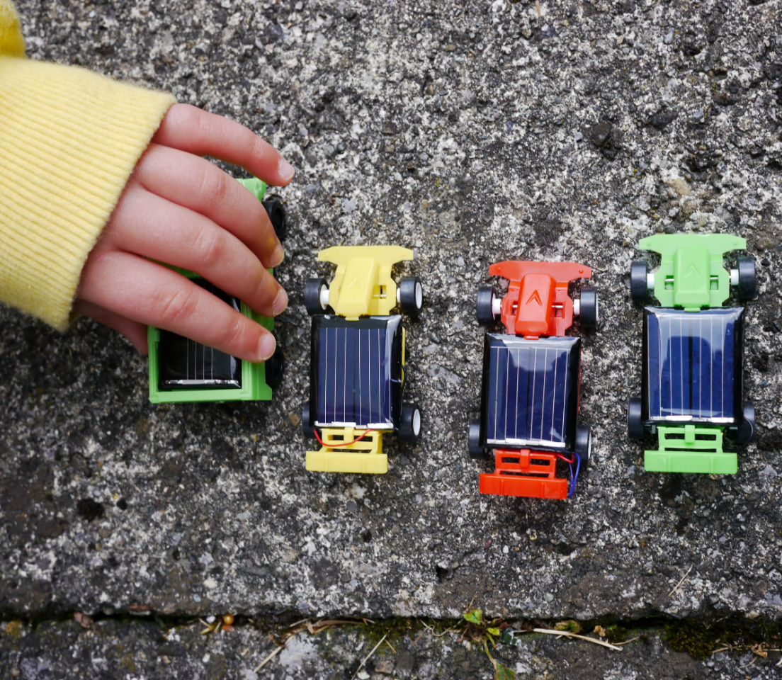 Child playing with toy cars