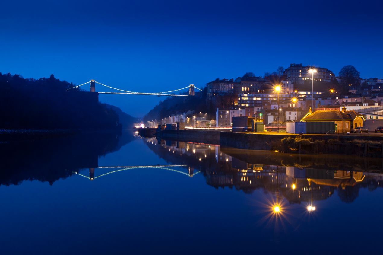 Lights from town reflecting on water