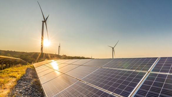 Solar panels and wind turbines at sunrise