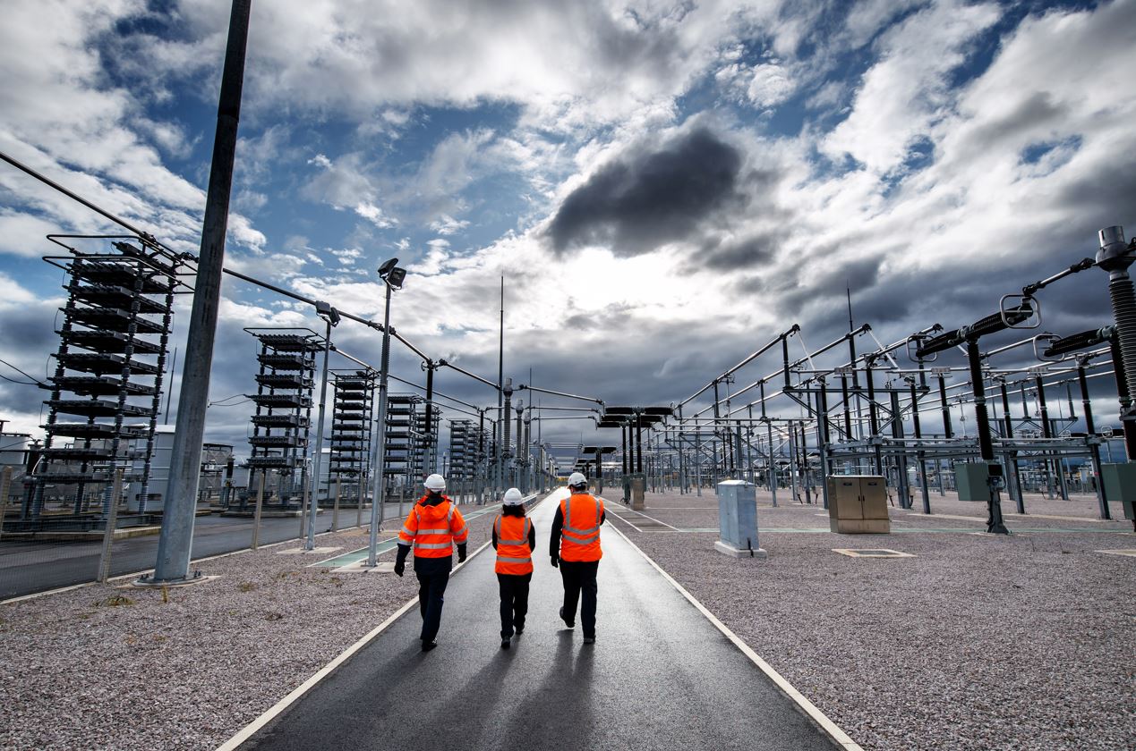 Power station workers walking into distance