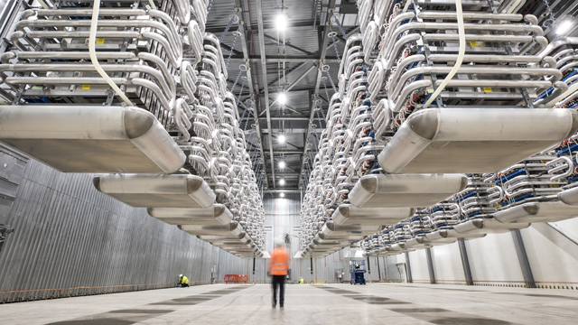 Engineer wearing PPE standing in the valve hall of the IFA2 interconnector