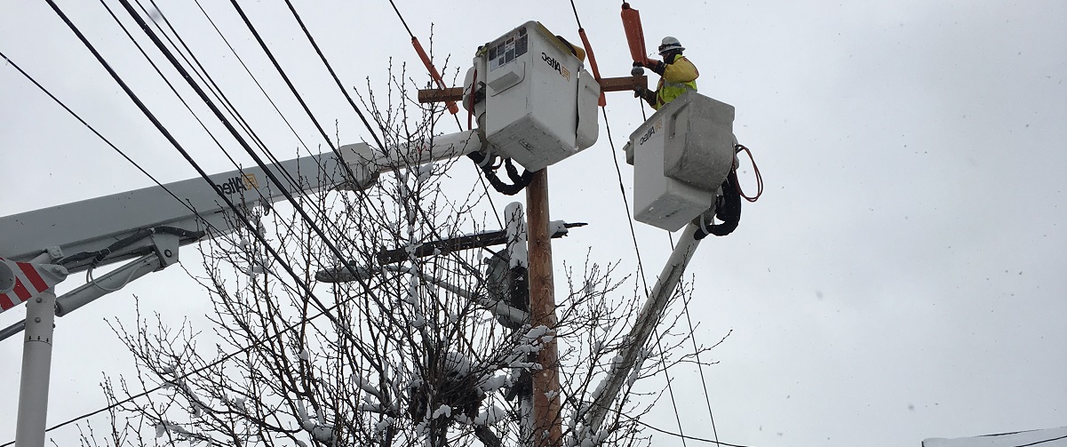 National Grid lineworker fixing a power line in the snow in the US