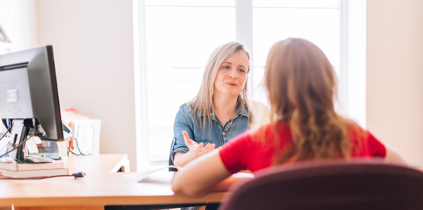 Two women talking at work