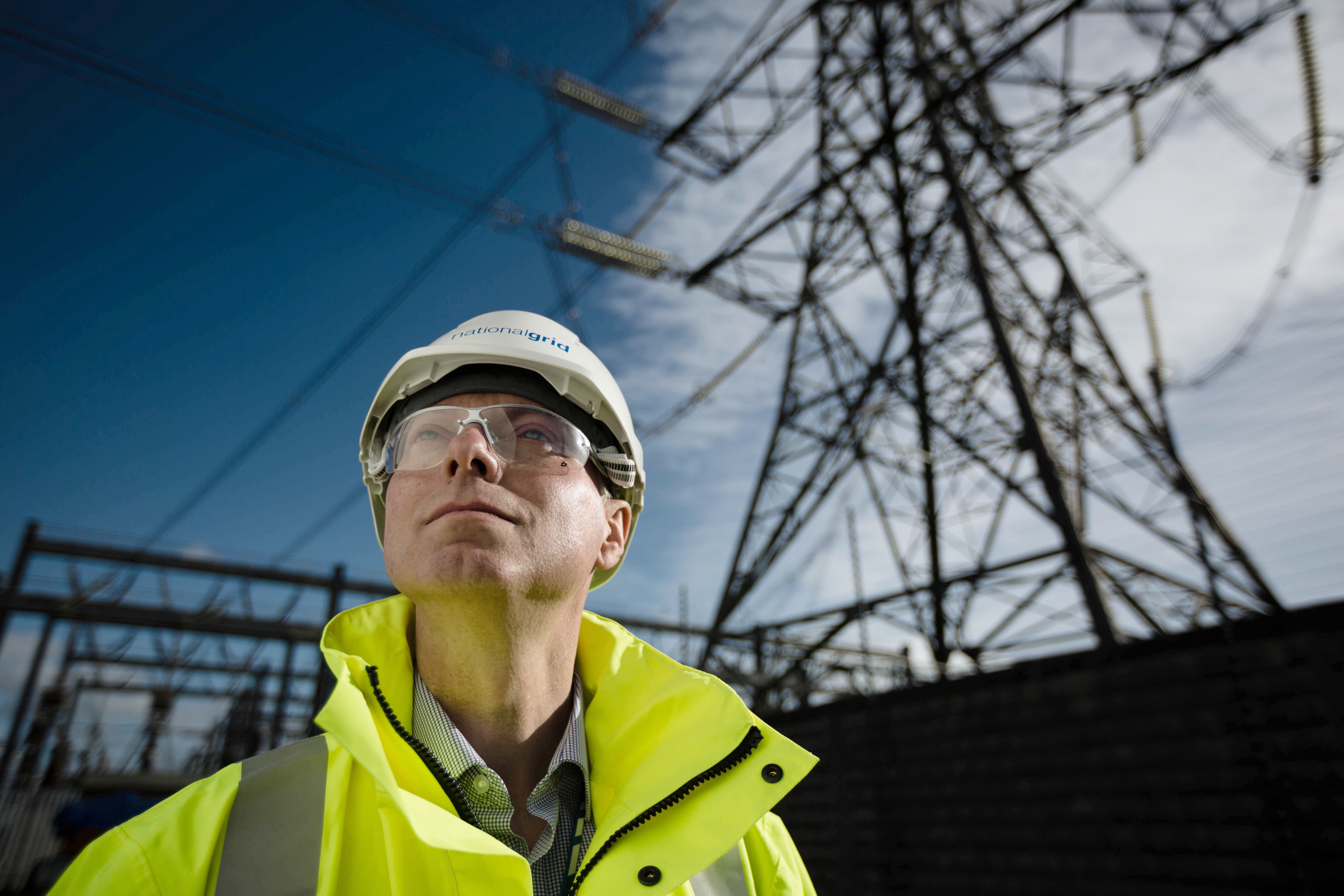 National Grid Project Manager Paul Daniels portrait with electricity pylon in the backrground
