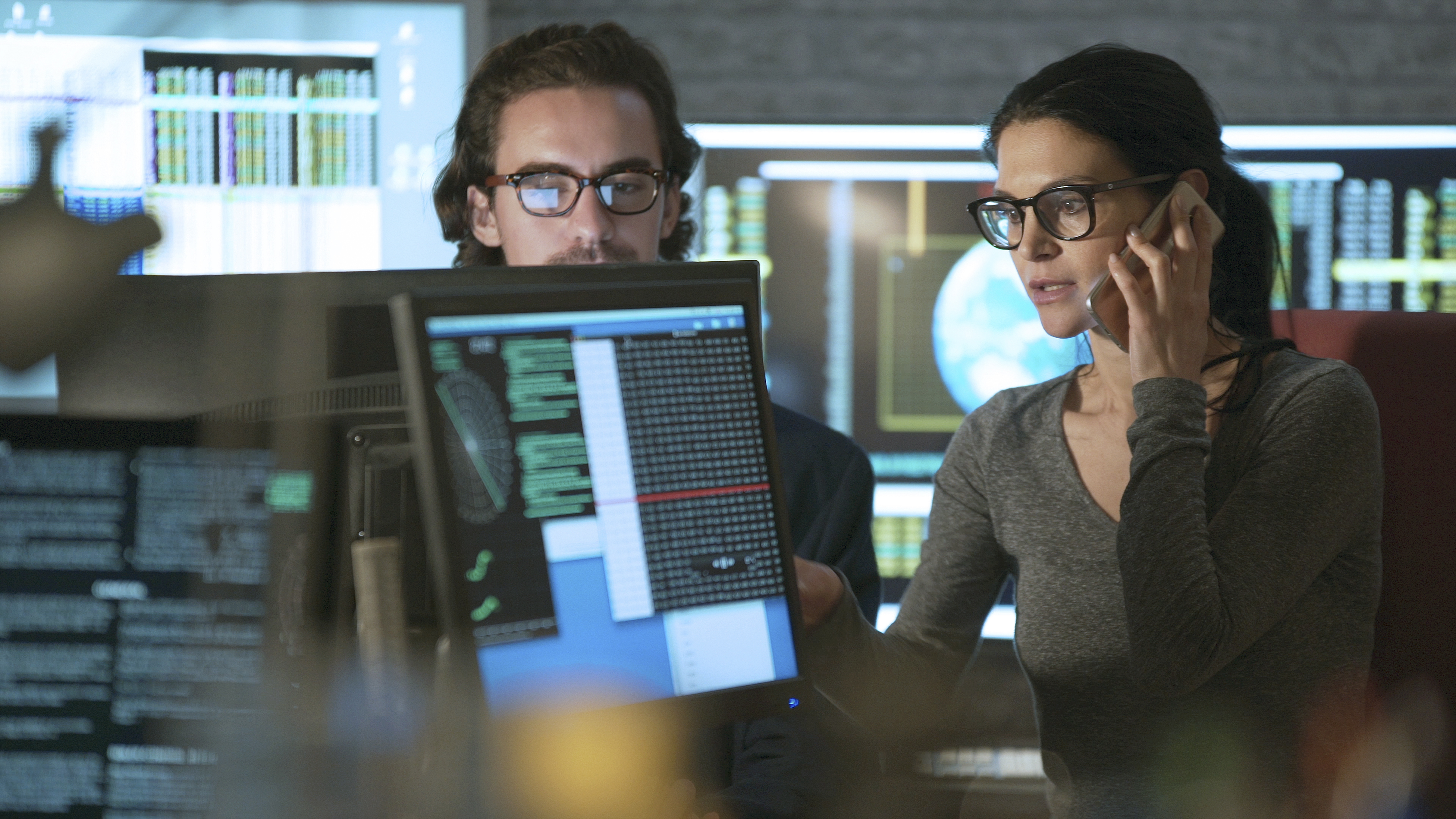 Two people looking on computer