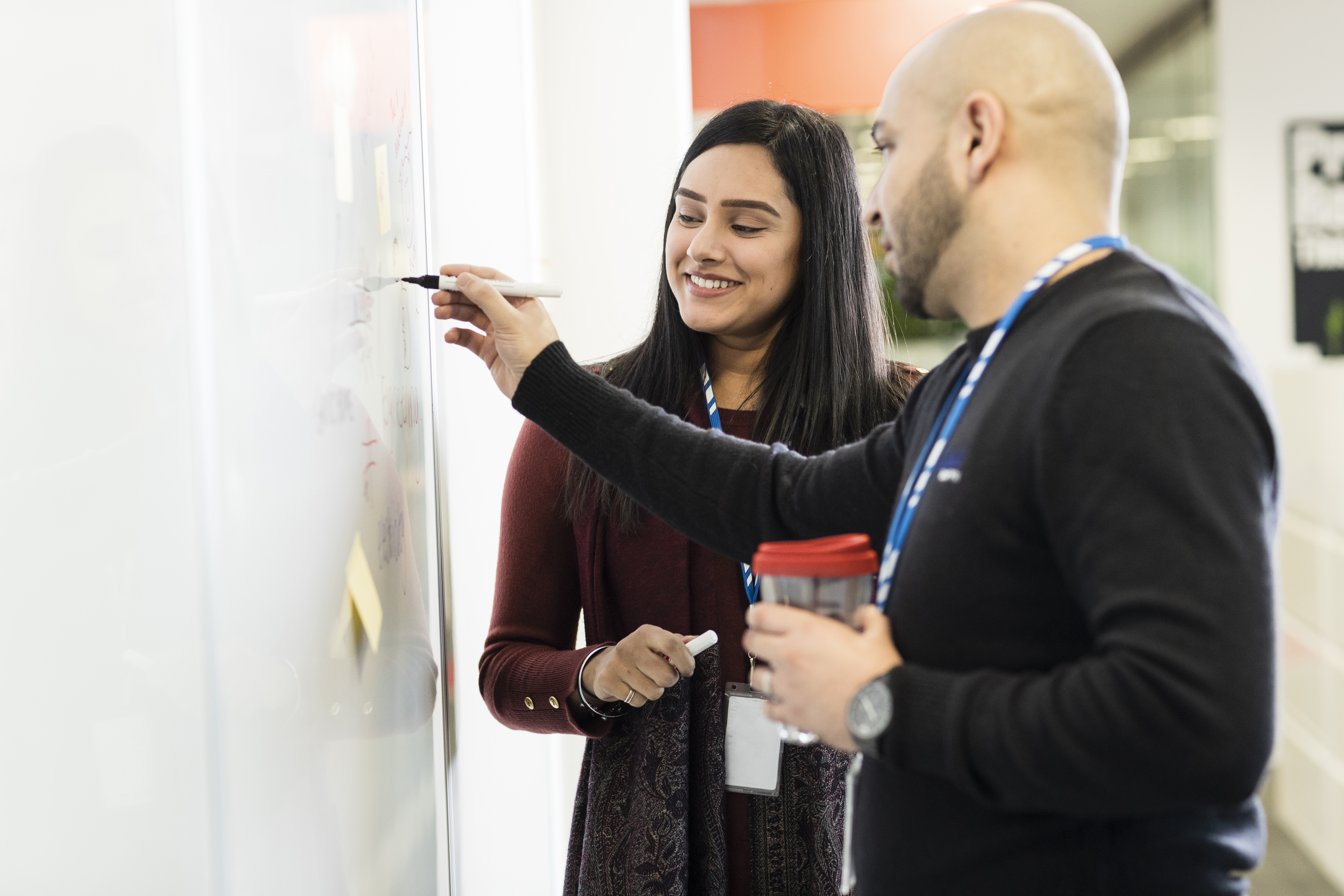 Two people using whiteboard