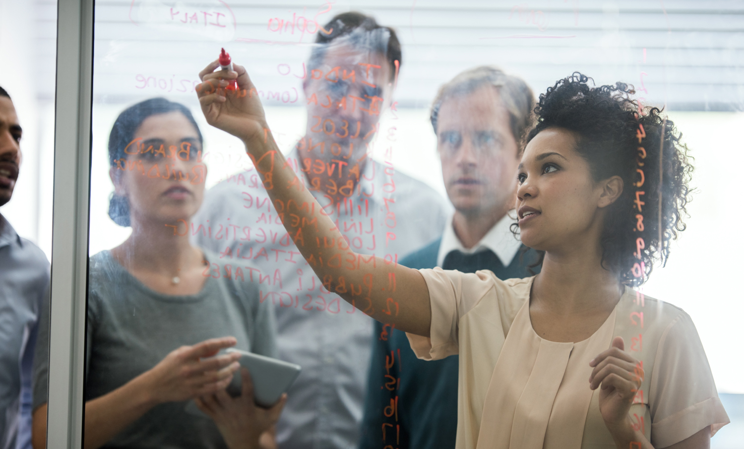 People standing behind glass noticeboard used for National Grid research and development page