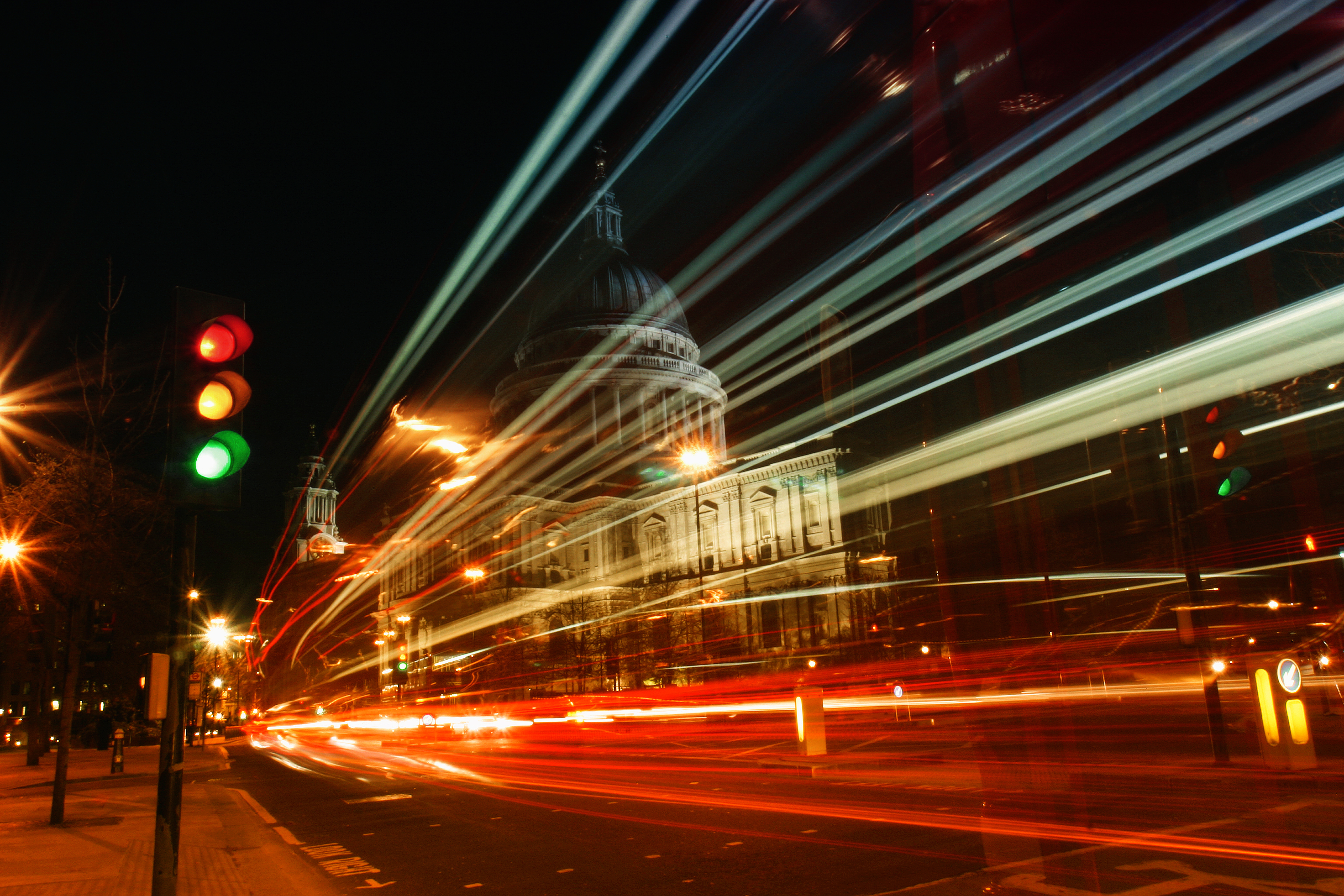 Night-time image of a busy road and traffic lights in a city 
