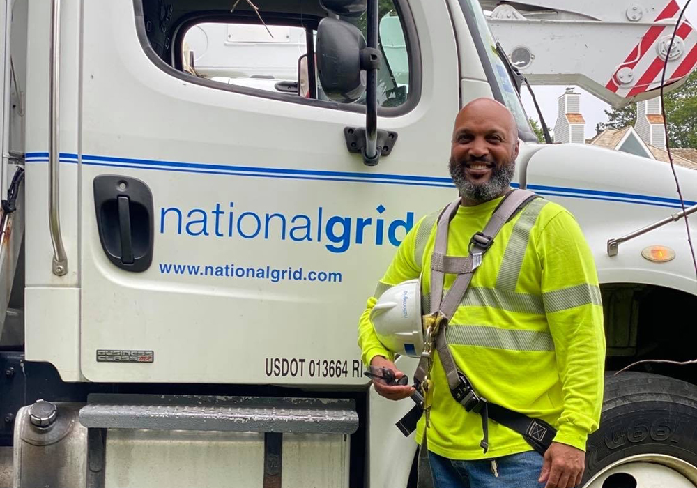 US Lineworker Donald Lopes in front of National Grid bucket truck