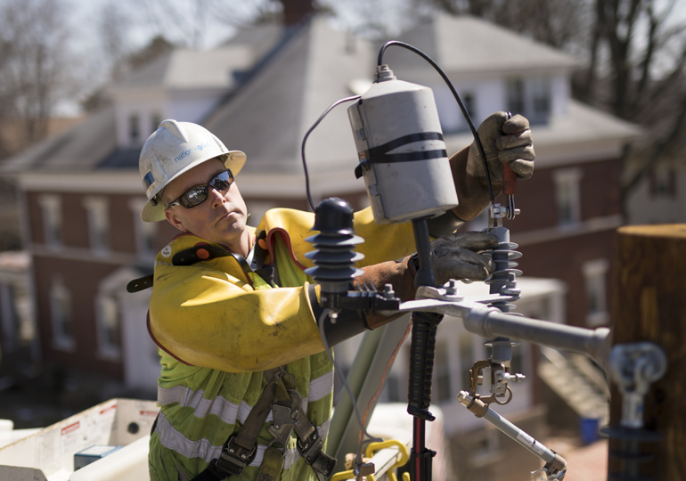 Linesman wearing PPE working on overhead line