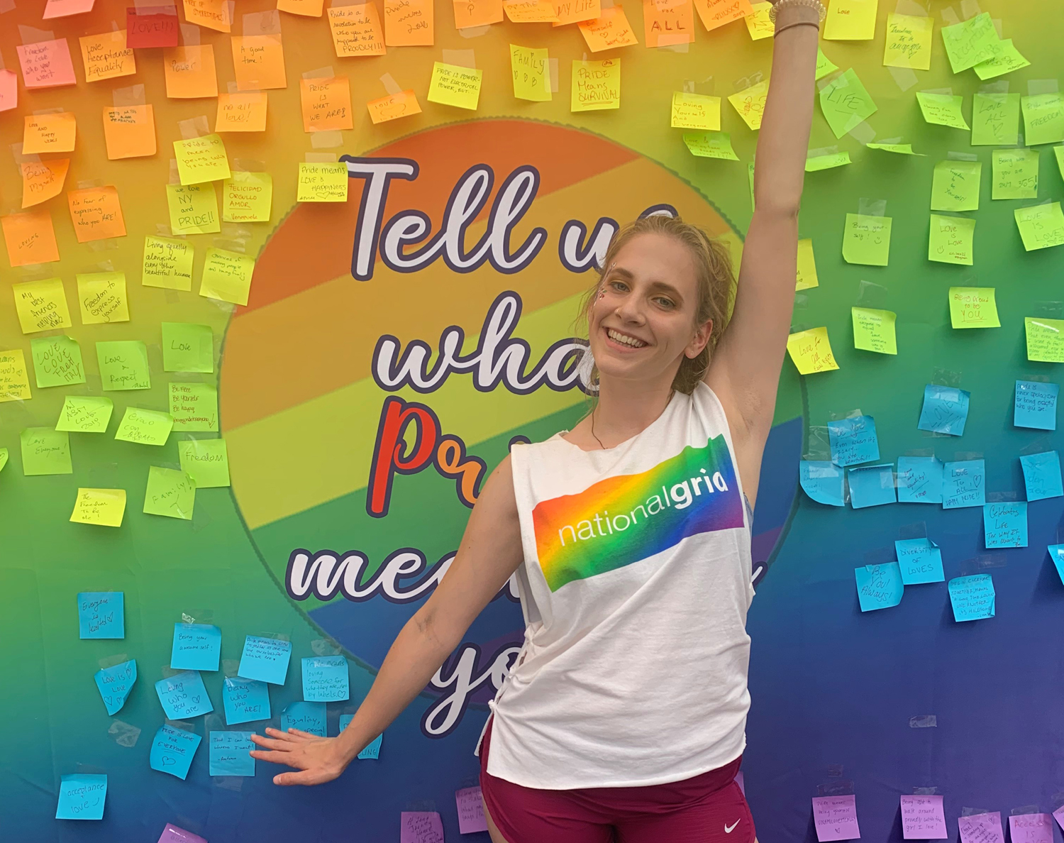 National Grid Pride colleague in front of colourful board with posters