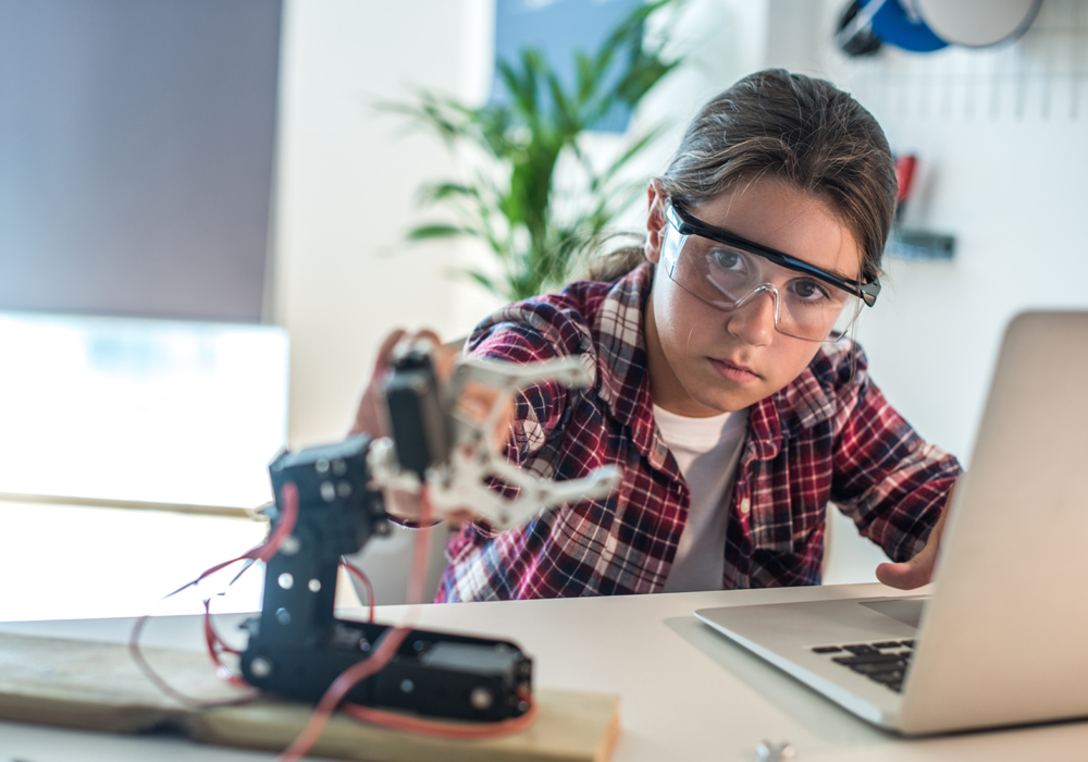 Young girl working with robotics for National Grid 'Inspiring female engineering talent story' for INWED