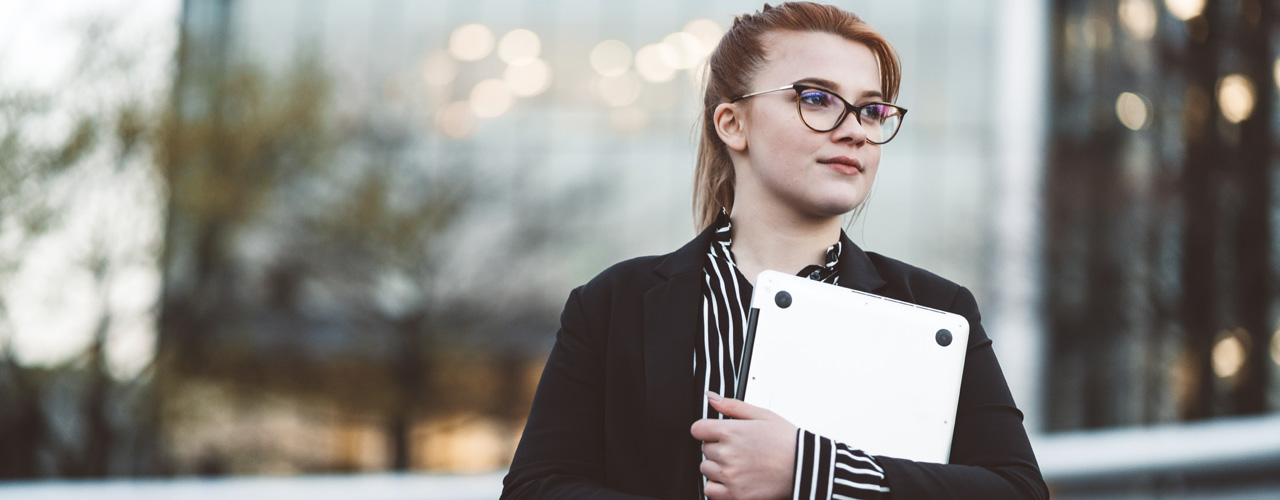 Young woman holding laptop used for National Grid US virtual internships story