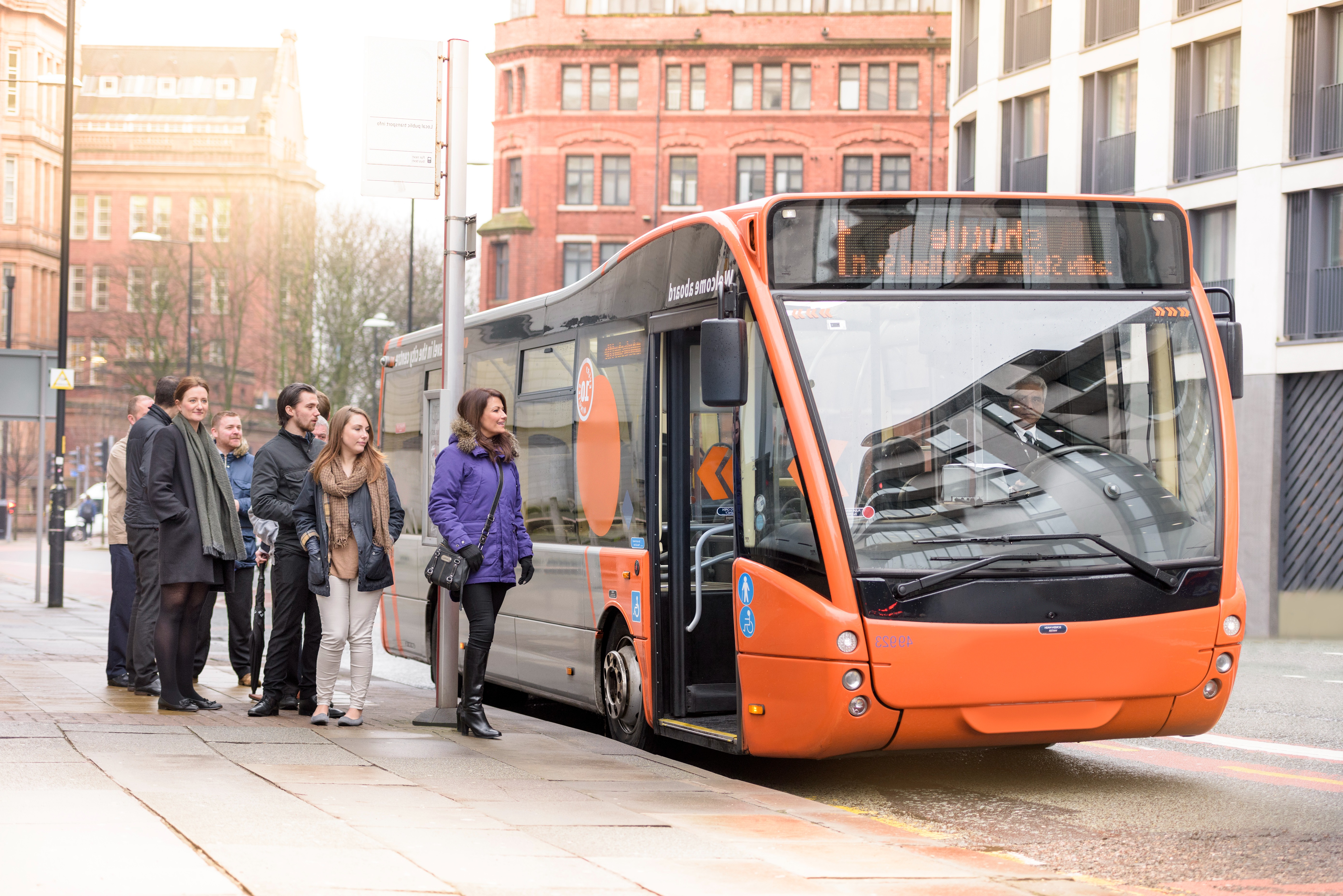 People waiting in a bus queue