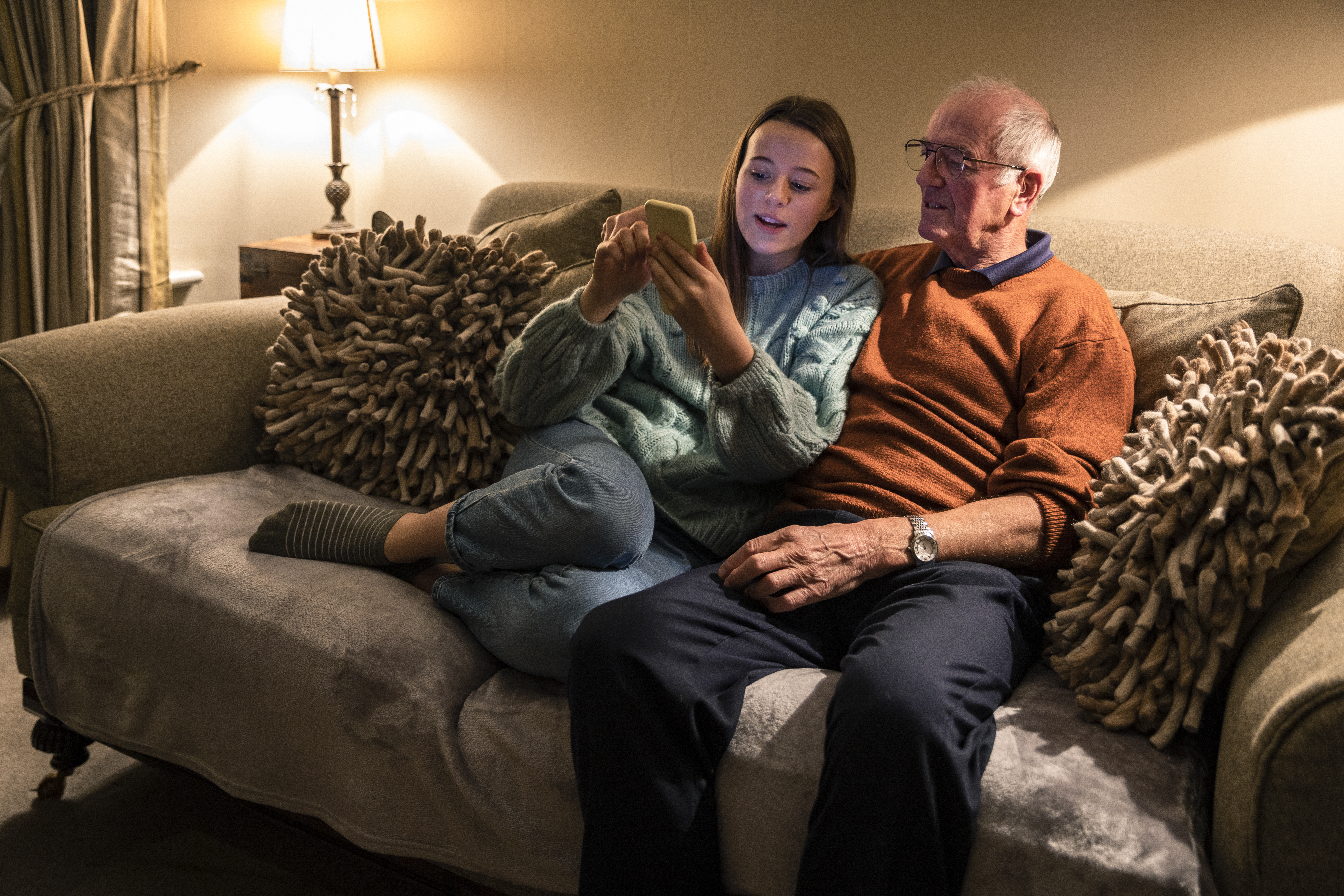 Girl and elderly man looking at a phone.jpg