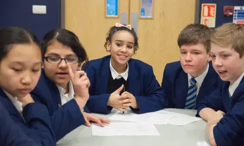 Young students sitting around a table