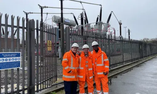 Three people at a substation in PPE