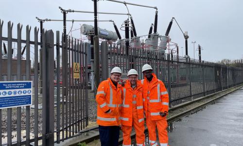 Three people at a substation in PPE