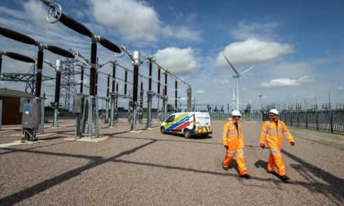 Workers walking near substation