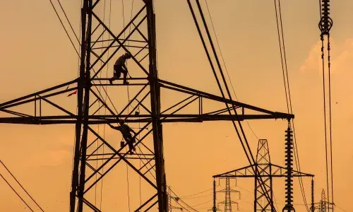 A pylon being refurbished at sunset