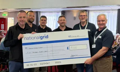 An image showing NGV and Veterans Outreach Support staff with a cheque at the donation handover.
