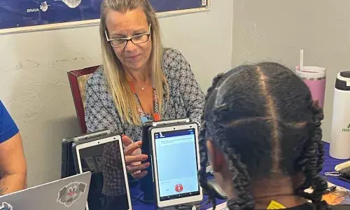 A National Grid customer advocate using TranslateLive to communicate with a customer at a recent event in Brockton, Mass., on Thursday, August 27, 2026. 