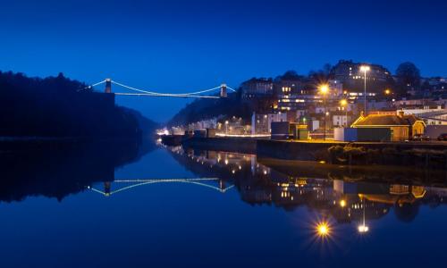 Lights from town reflecting on water