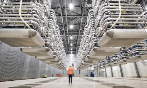 Engineer wearing PPE standing in the valve hall of the IFA2 interconnector