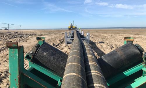 Interconnector cables being pulled across a beach - used for the National Grid article 'Connecting electricity systems for a greener Britain'