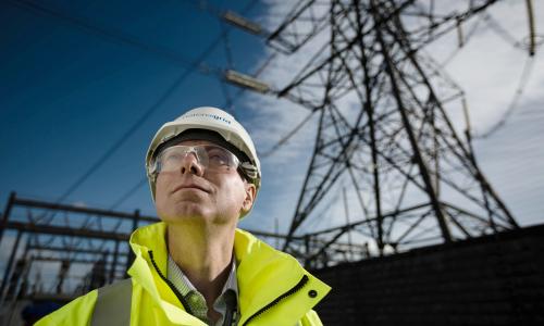 National Grid Project Manager Paul Daniels portrait with electricity pylon in the backrground